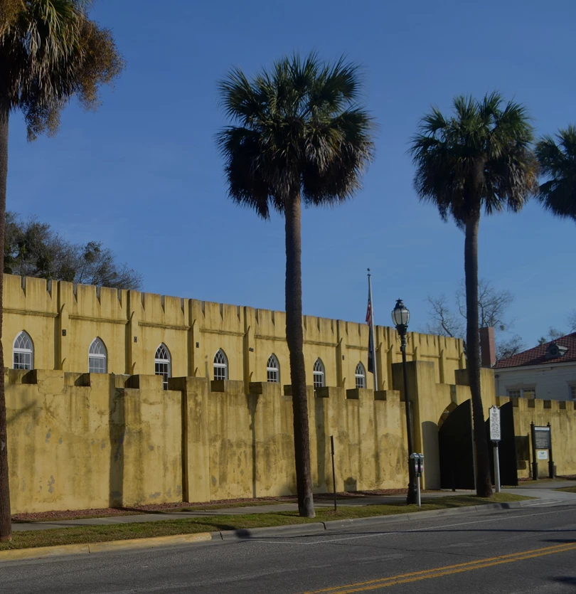 a building with palm trees and a street