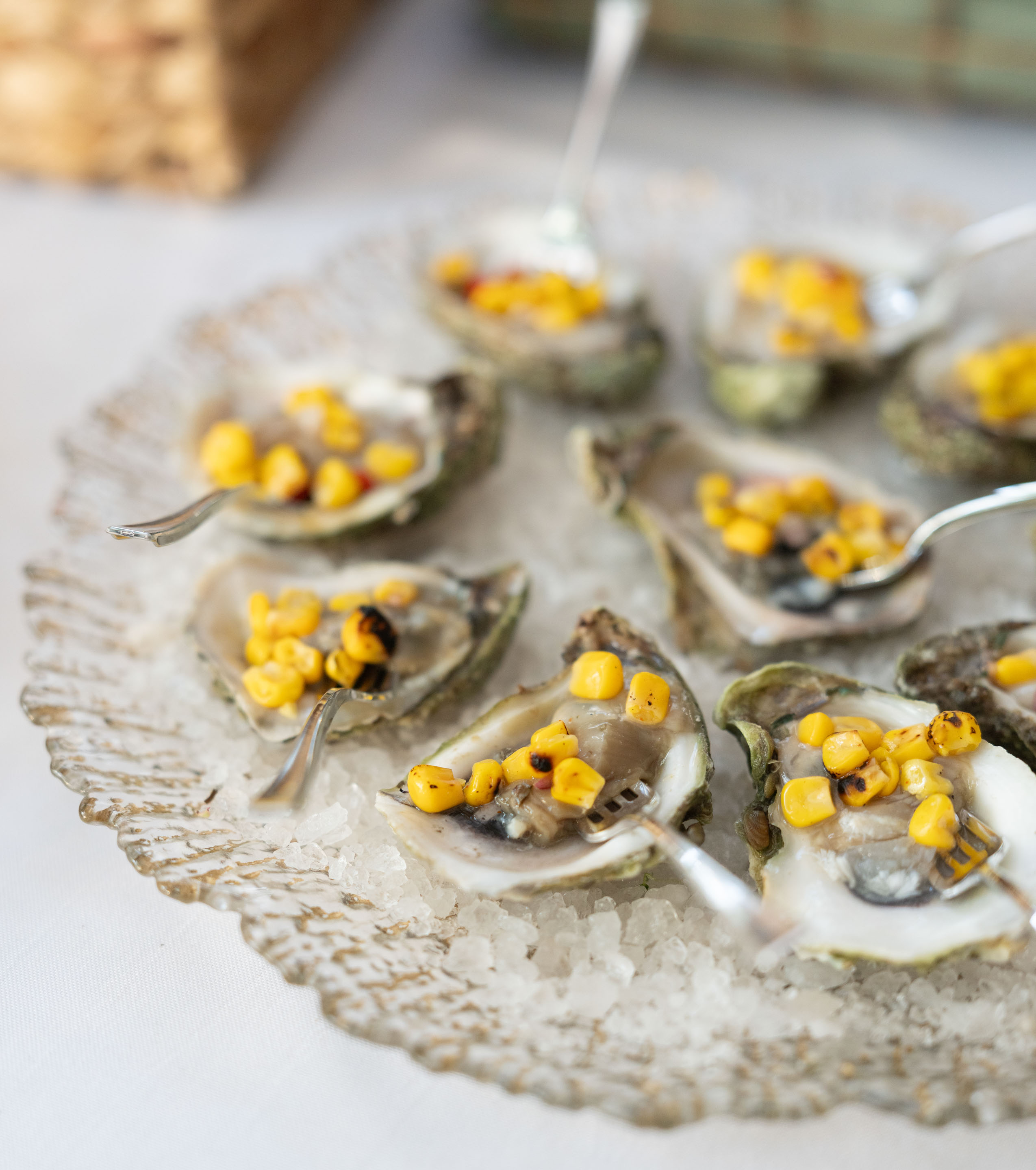 a plate of oysters with spoons