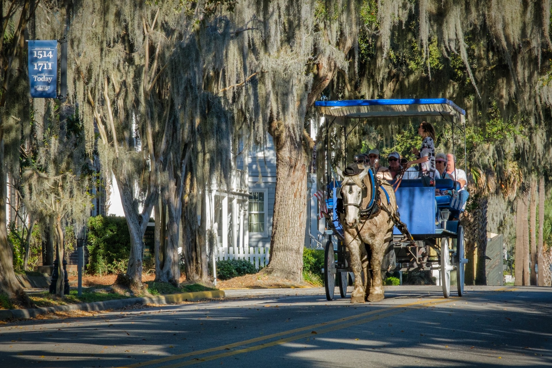 a horse carriage with people on it