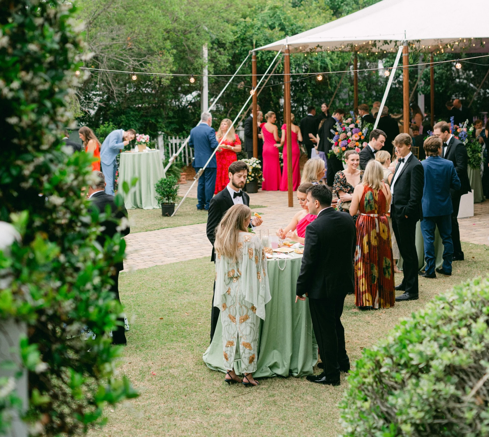 a group of people standing around a table