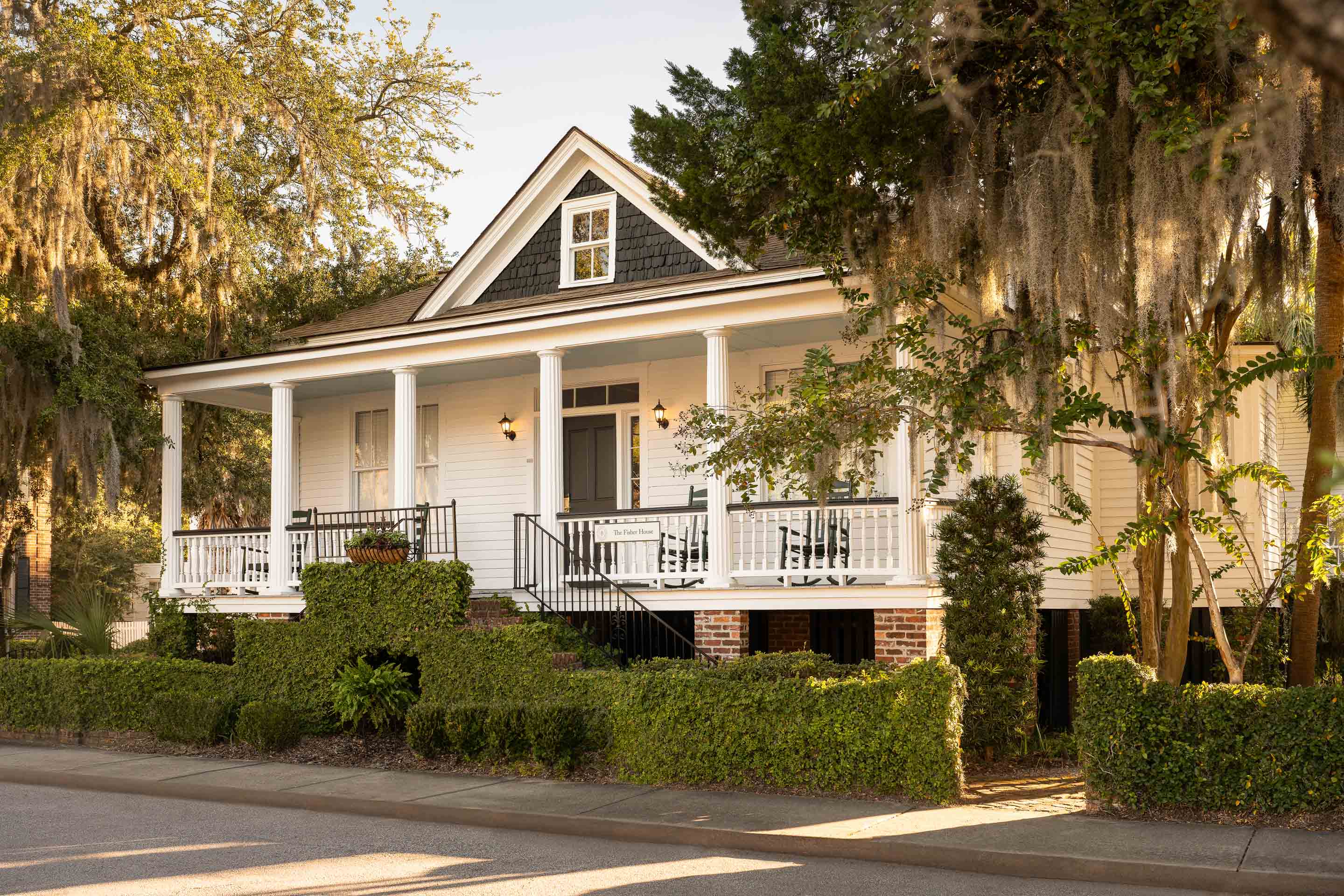 a house with a porch and a tree