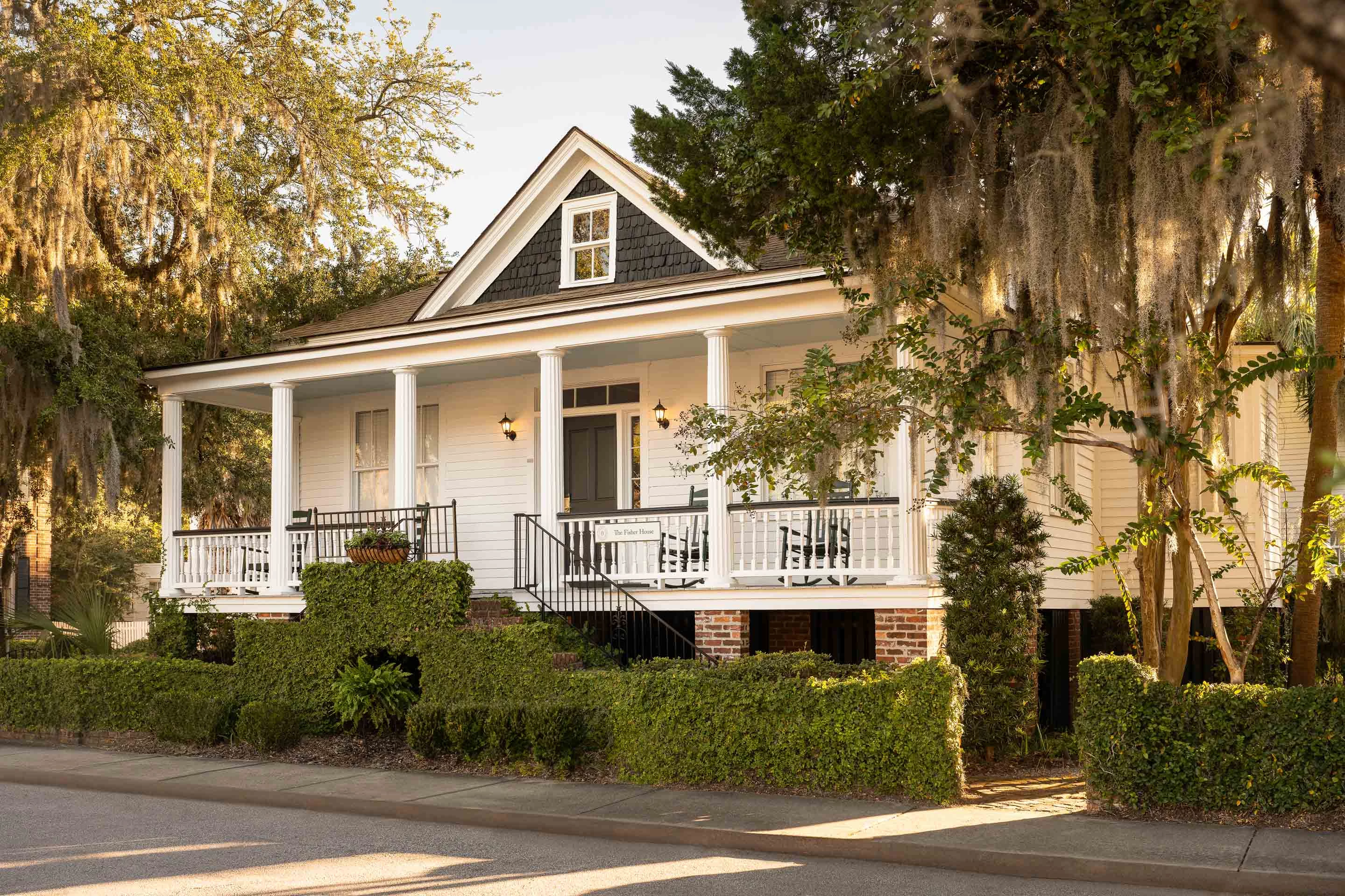 a house with a porch and a tree