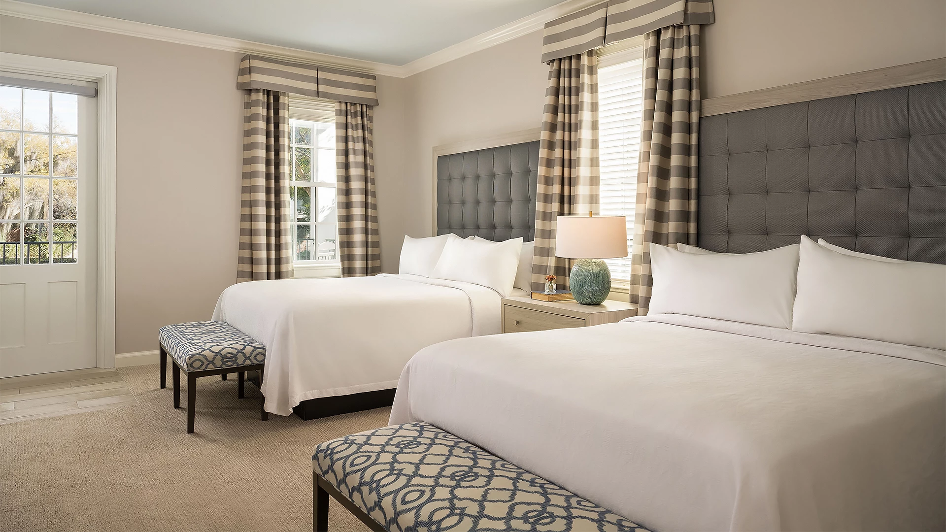 a room with two beds and a lamp