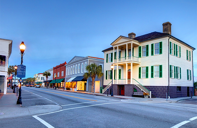 a street with buildings and palm trees