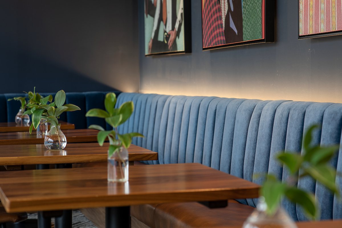 a table with plants in vases on a booth