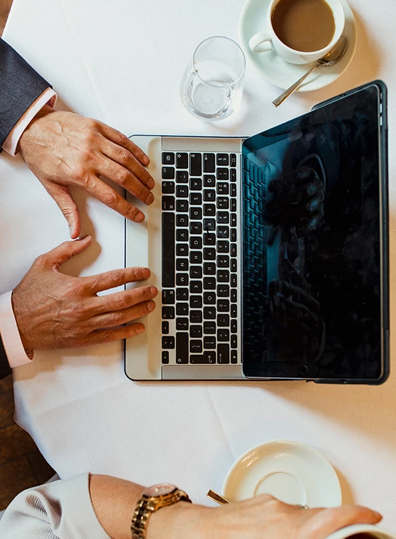 a man's hands on a laptop