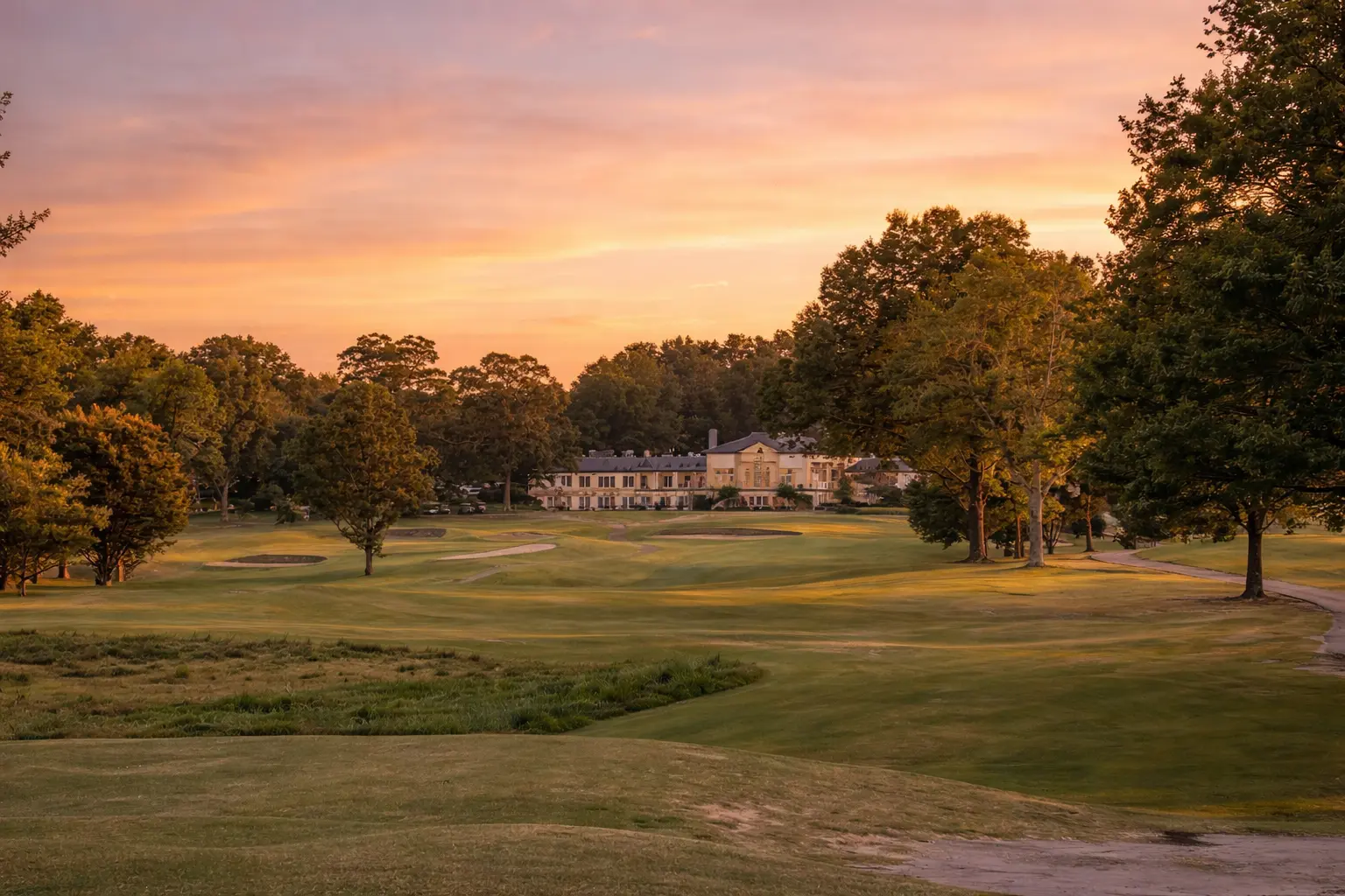 a large golf course with a building and trees