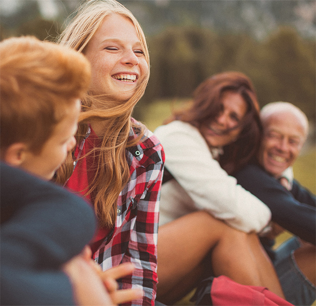 a group of people sitting on grass