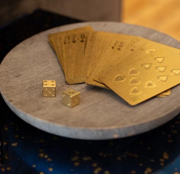 a group of cards and dice on a circular surface