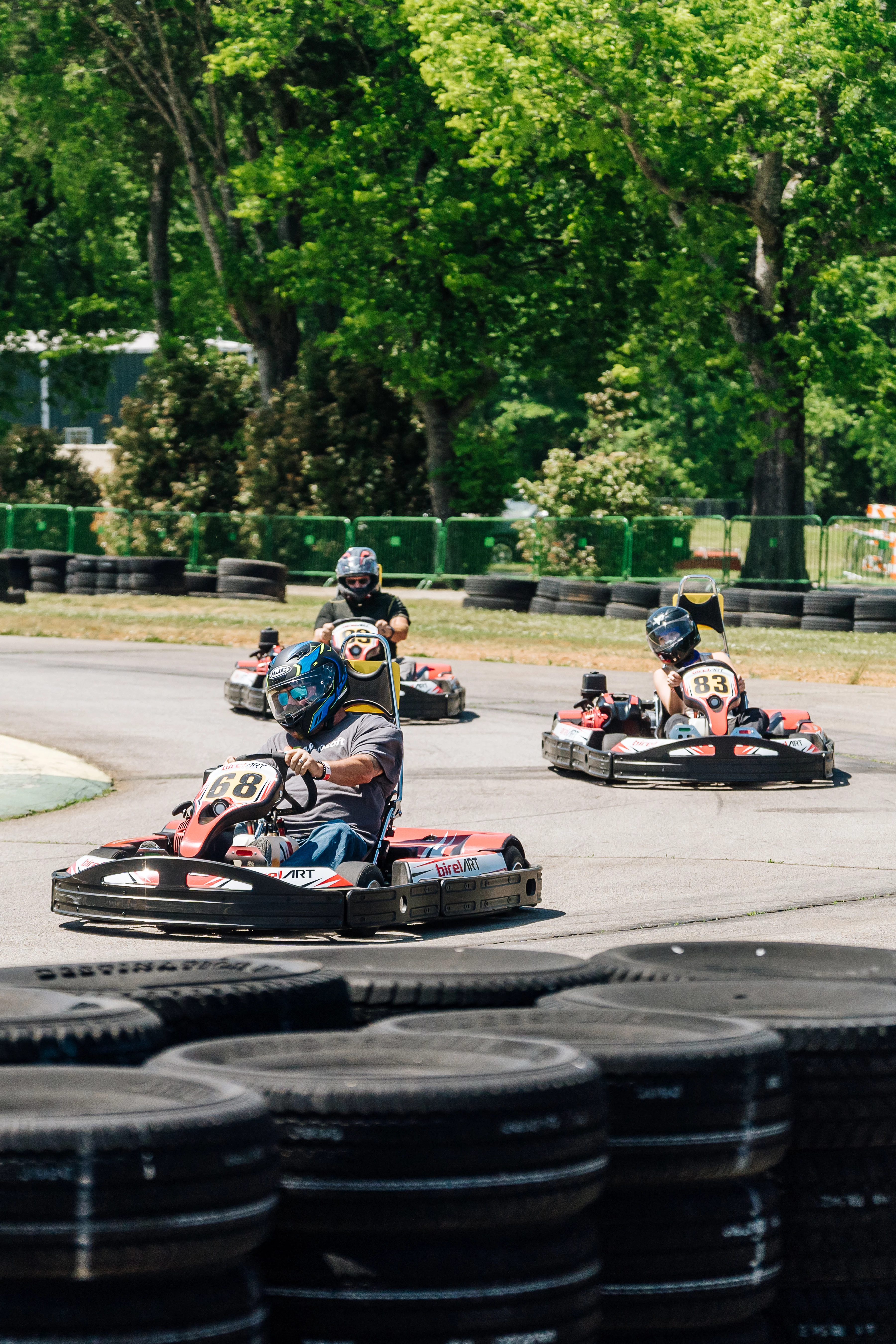 a group of people driving go karts on a track