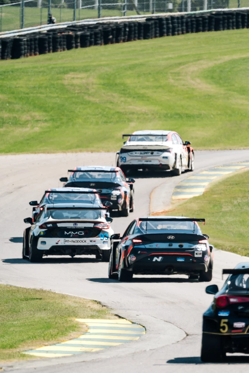 a group of race cars on a road