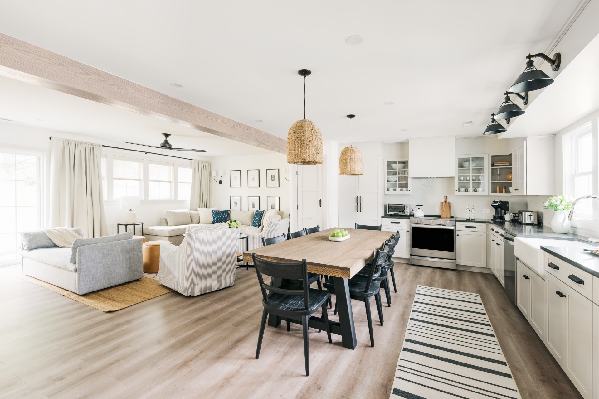 a kitchen and living room with a table and chairs
