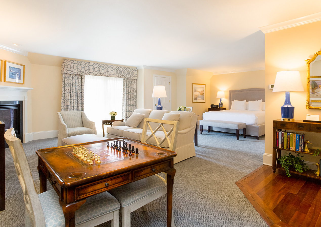 a large living room with a large bed and a coffee table