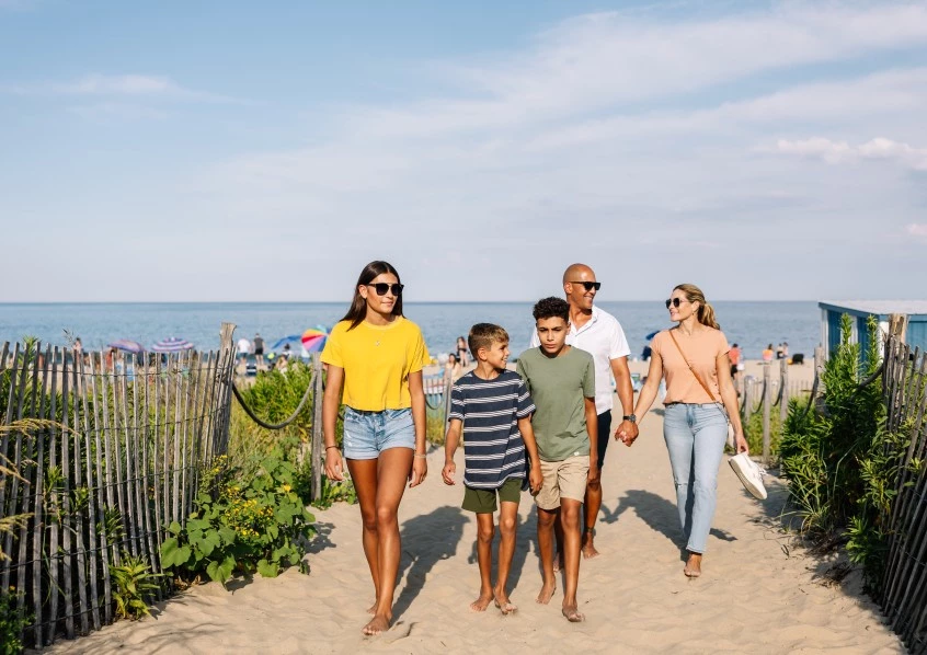 a group of people walking on a beach