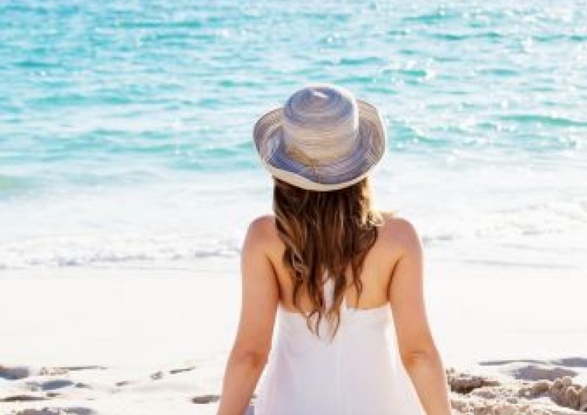 a woman sitting on the beach