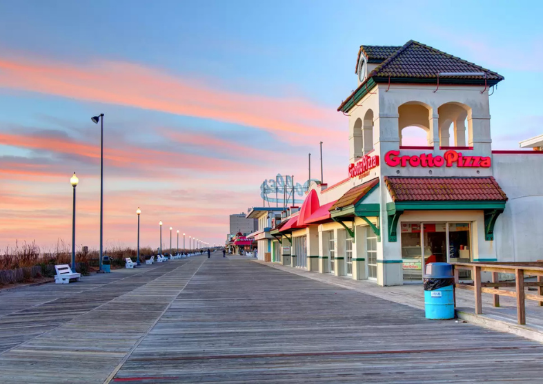 a boardwalk with a building and a sign