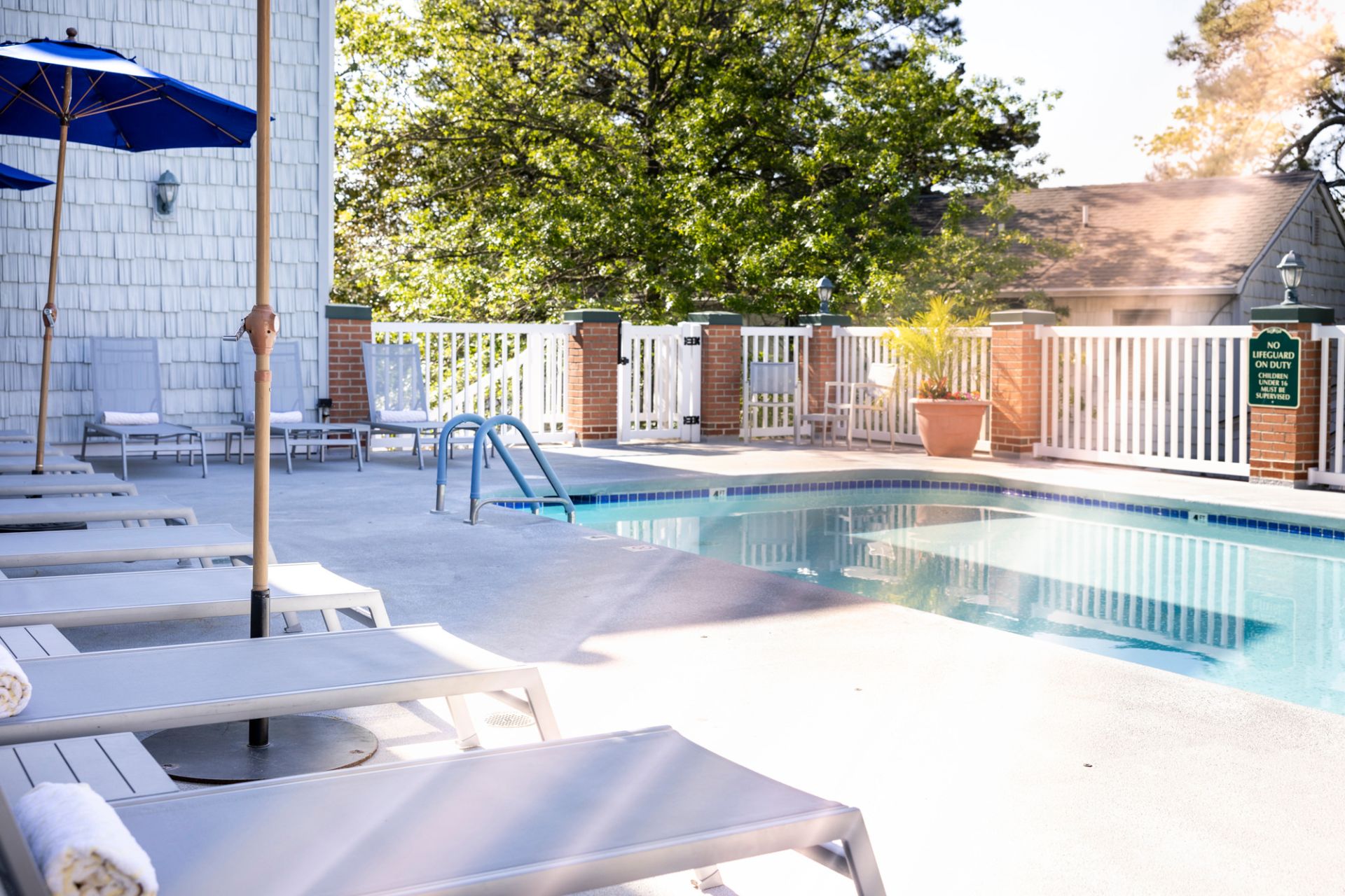 a pool with chairs and umbrellas