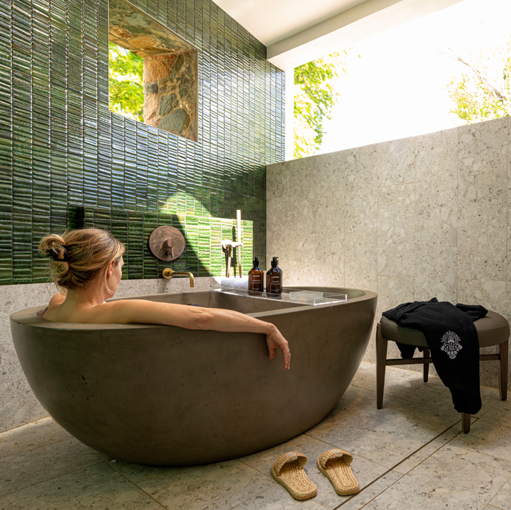 a woman sitting in a round bathtub
