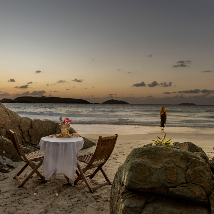 a table and chairs on a beach