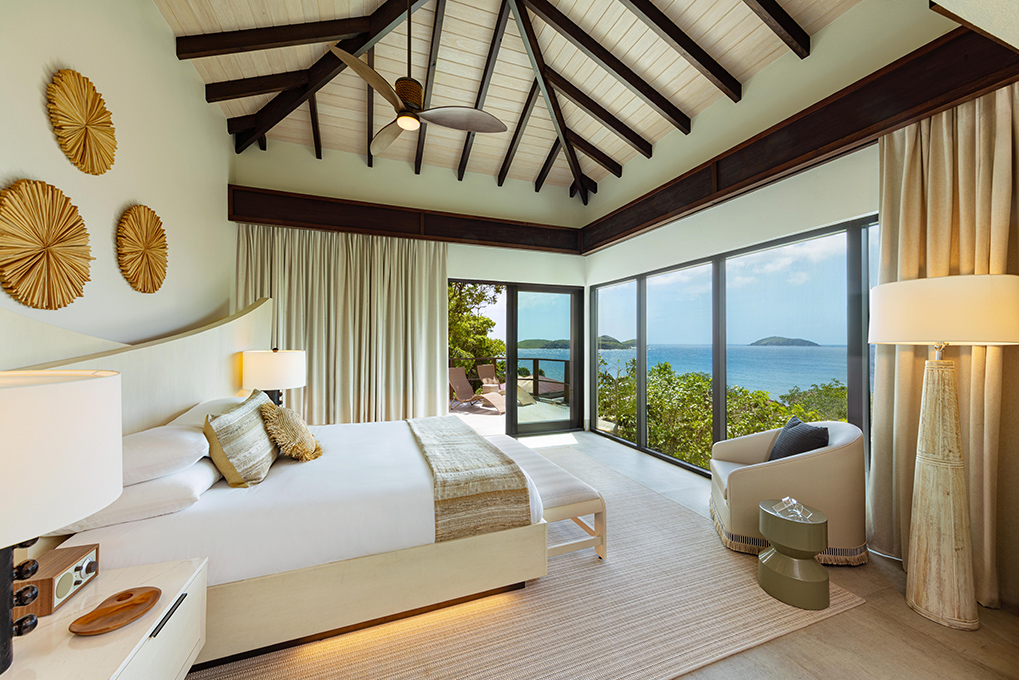 a bedroom with a view of the ocean