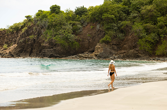 a woman walking on a beach