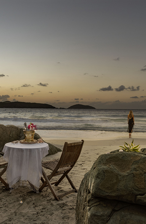 a table and chairs on a beach