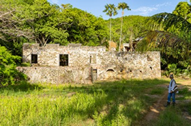 a stone building with trees in the background