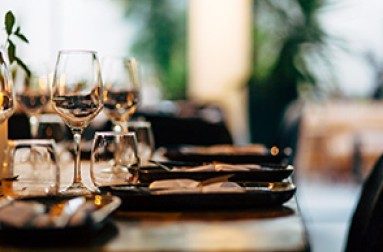 a table with wine glasses and plates