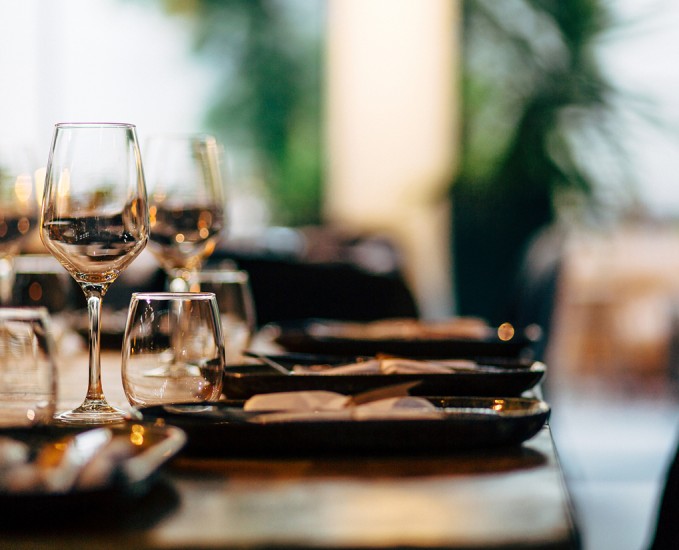 a table with wine glasses and plates