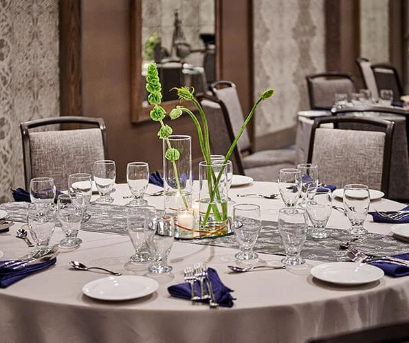 glassware, flowers and plates on a round table