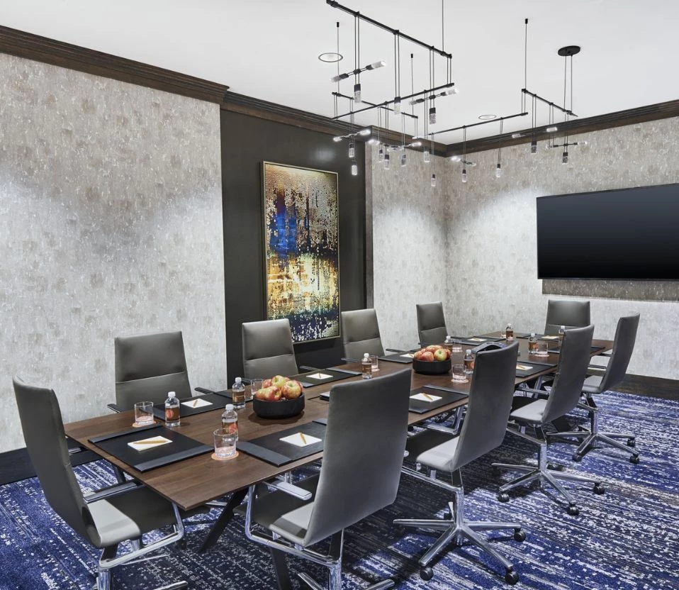 a conference room with a table and chairs