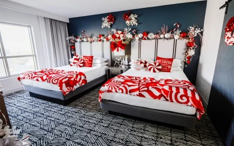 two beds with red and white candy cane holiday decorations