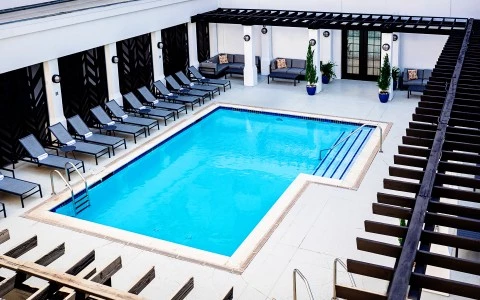 a pool with chairs and a deck chair