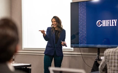 a woman standing in front of a screen
