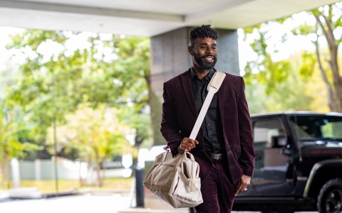 a man in a suit carrying a bag