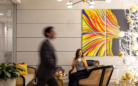 a man and woman in a room with a painting