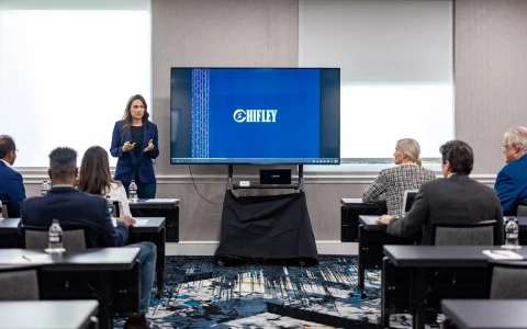 a woman standing in front of a screen