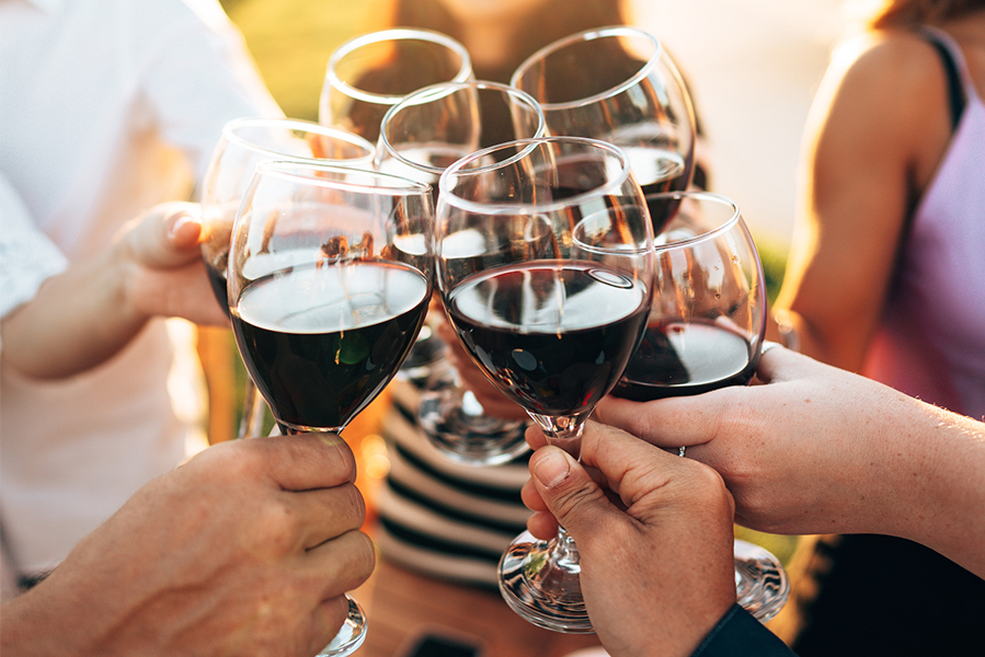 a group of people holding wine glasses
