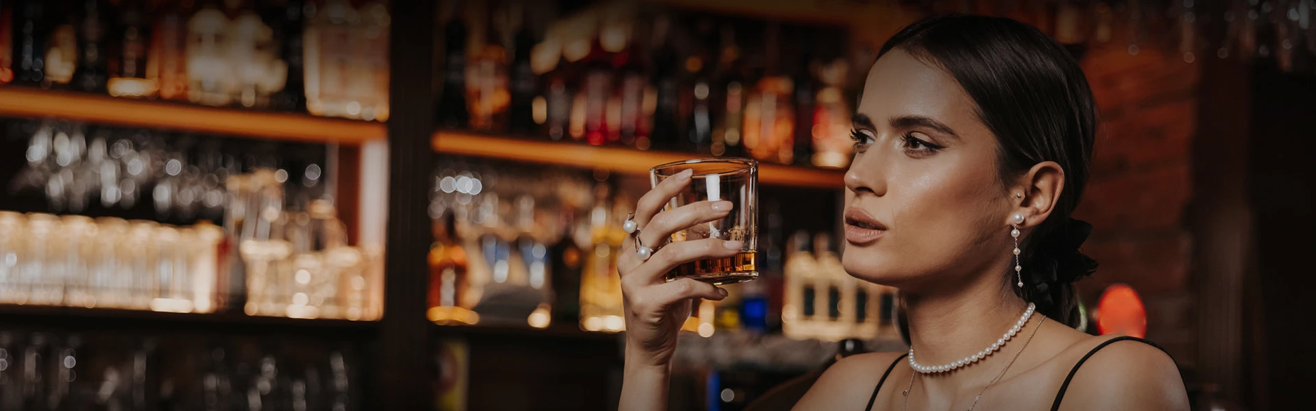 woman holding a whiskey glass