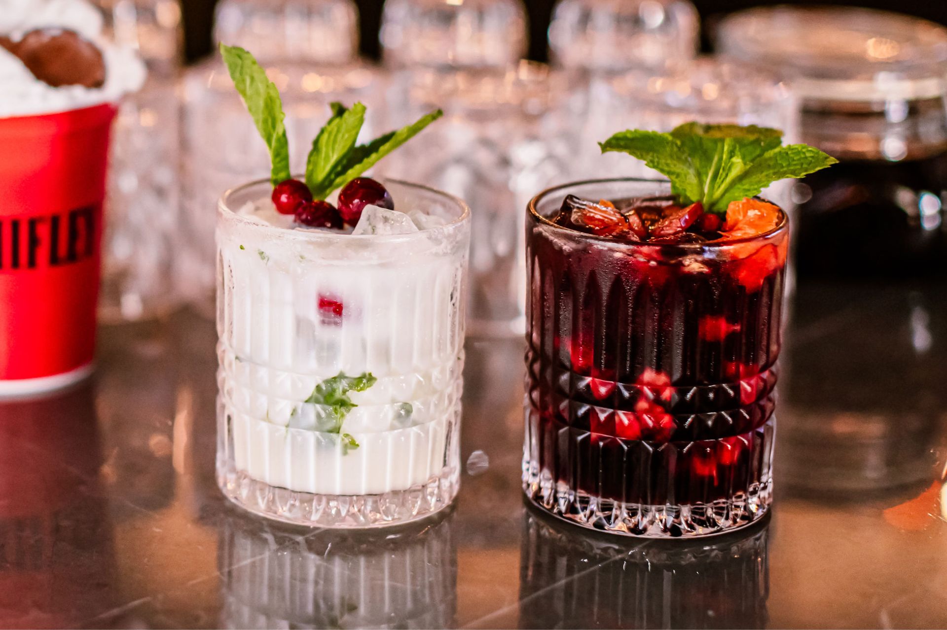 two glasses with drinks on a table