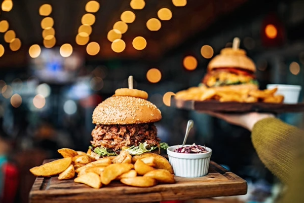 a hand holding a tray of food