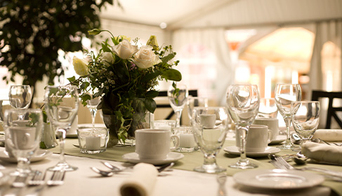 event table with bouquet of white roses as the centerpiece