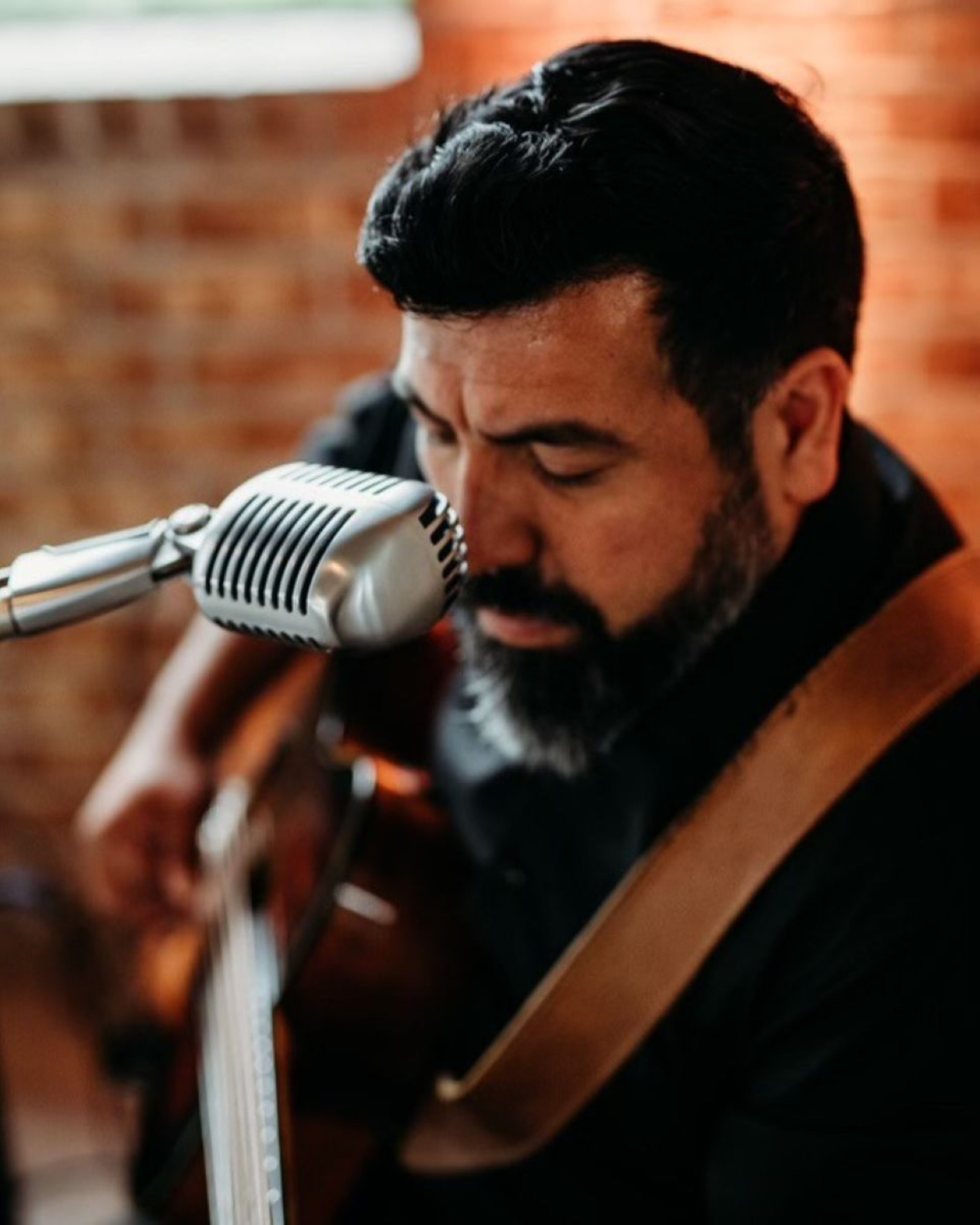 a person playing a guitar on a stage