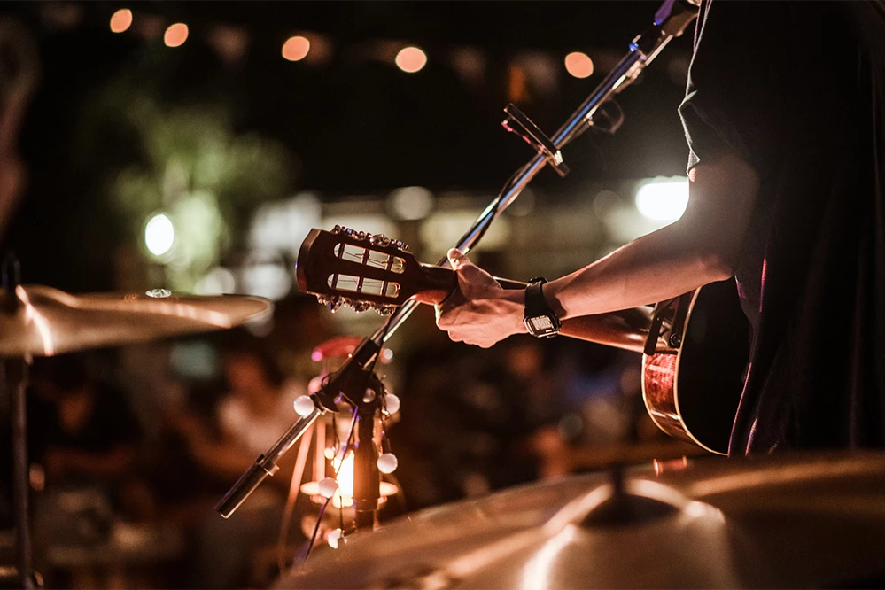 a person playing a guitar on a stage