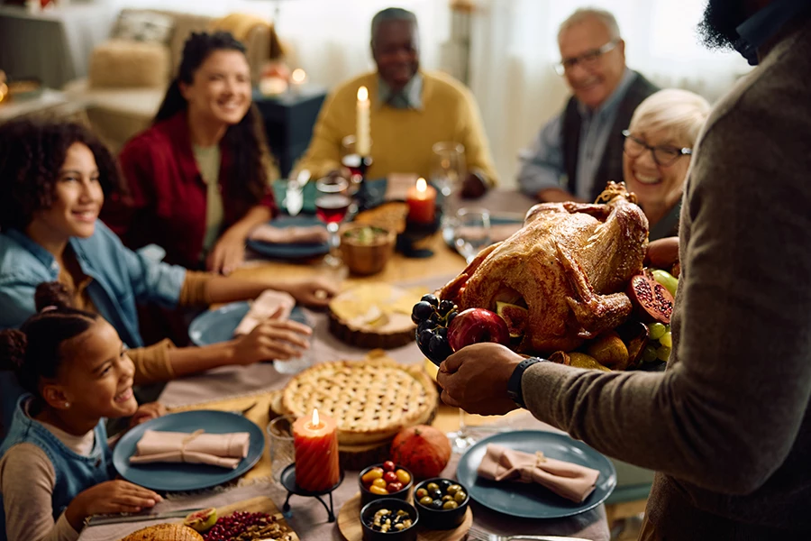 a group of people around a table with food