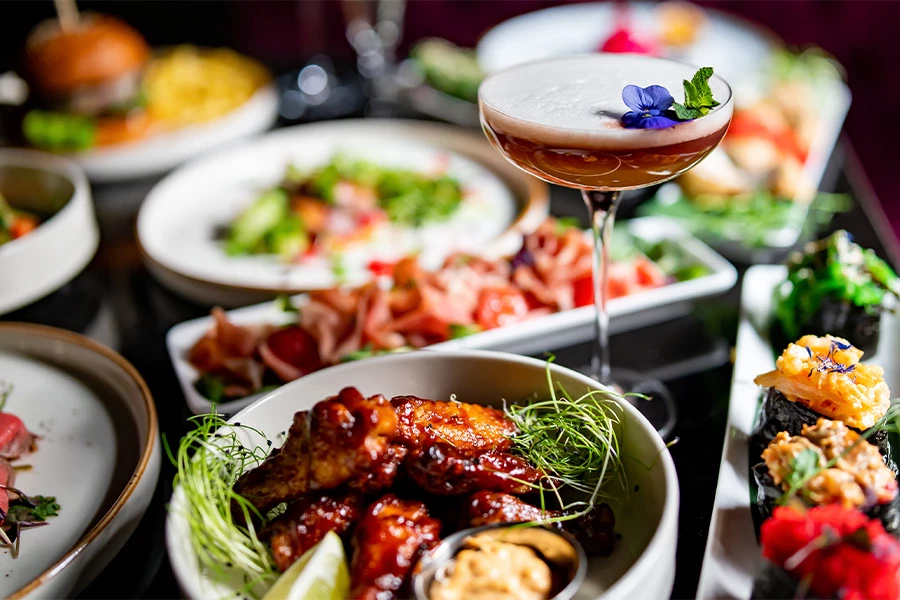 a table with plates of food and drinks