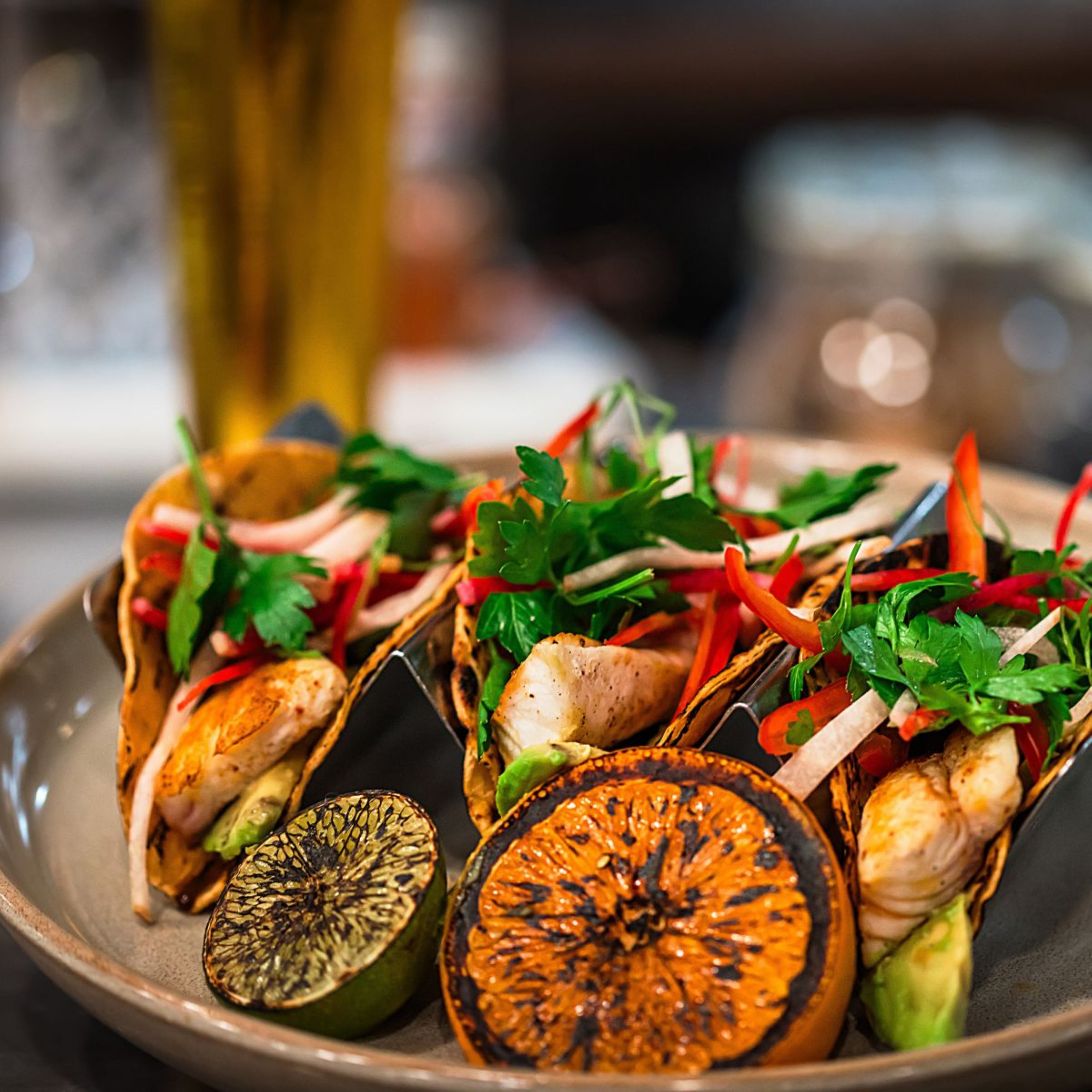 a plate of tacos on a wooden surface