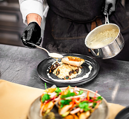 a person cooking food on a plate