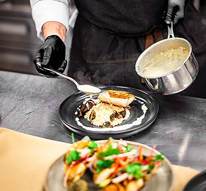 a person cooking food on a plate