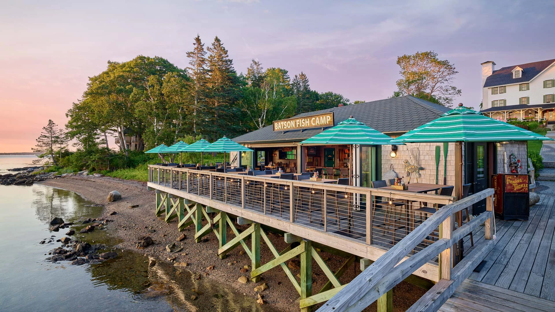 a building with a deck and umbrellas on the side of it